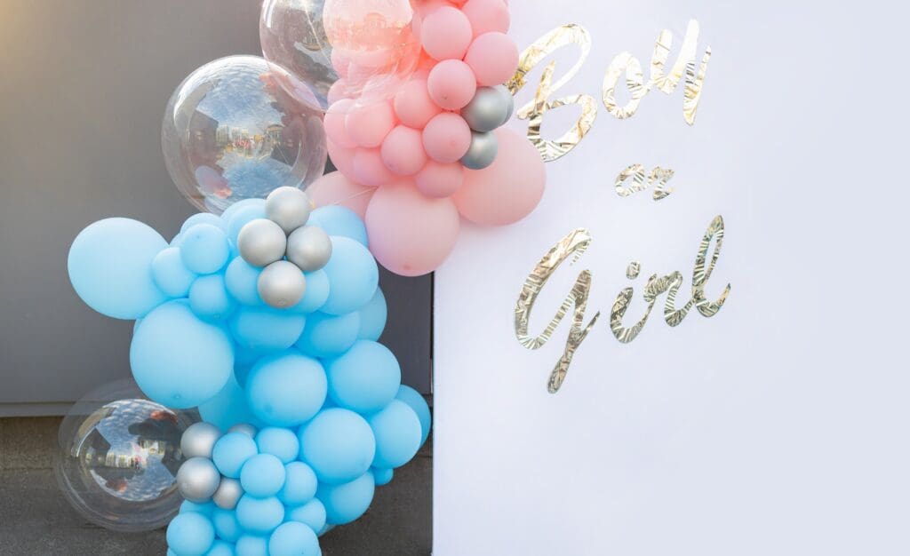 balloon with "boy or girl?" on gender reveal party. Gender party balls pink and blue.